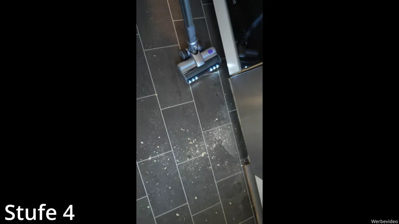 Narwal 40 Station Saugtest auf dunklen Fliesen mit sichtbarem Schmutz bei 06:46