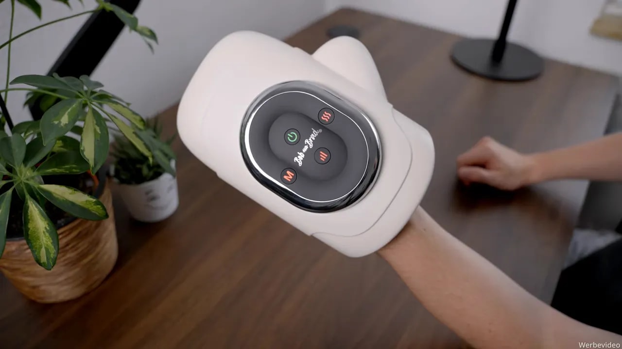 Handmassagegerät am Arm mit beleuchtetem Bedienfeld und roten Kontrollanzeigen