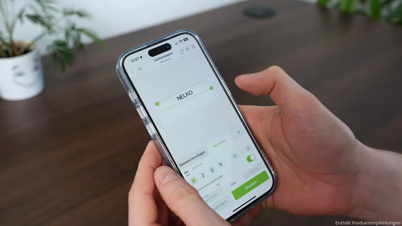 Smartphone with the NELKO app open for designing a label
