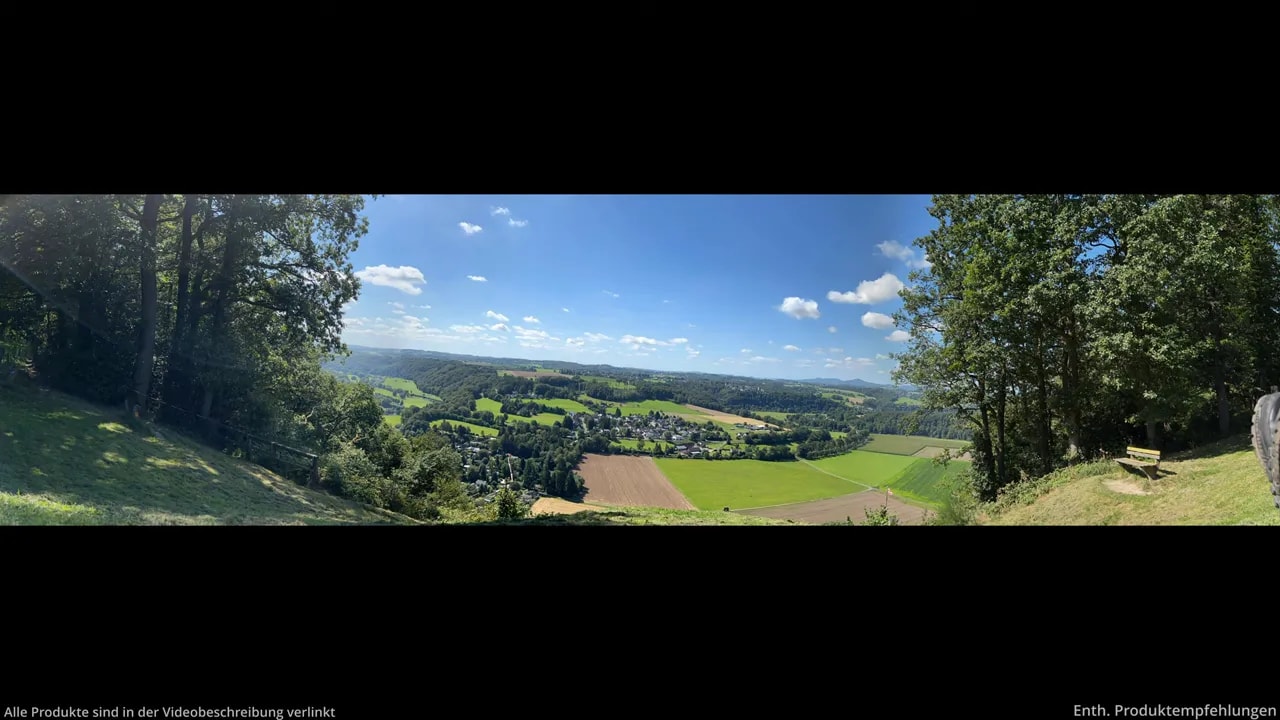 Breites Panorama einer grünen Landschaft unter blauem Himmel