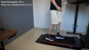 Person geht auf dem Walking Pad unter einem höhenverstellbaren Schreibtisch