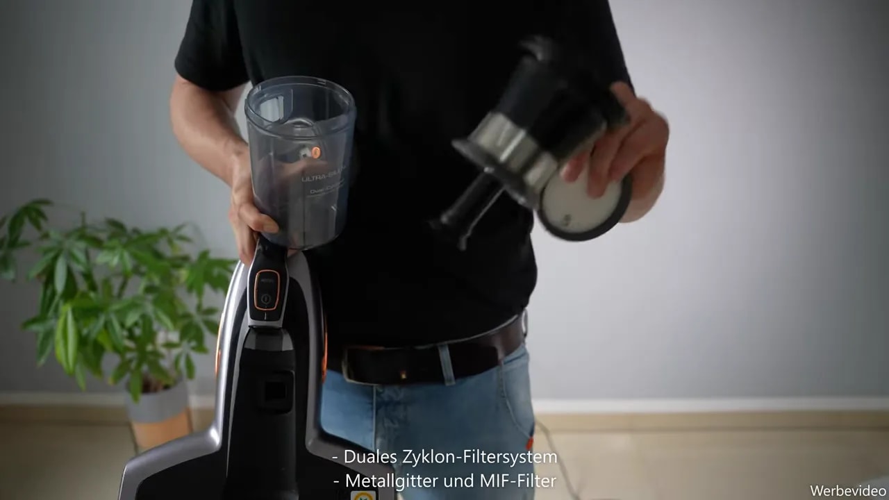 Zerlegter Staubbehälter mit Filtereinsatz und rundem Filterdeckel
